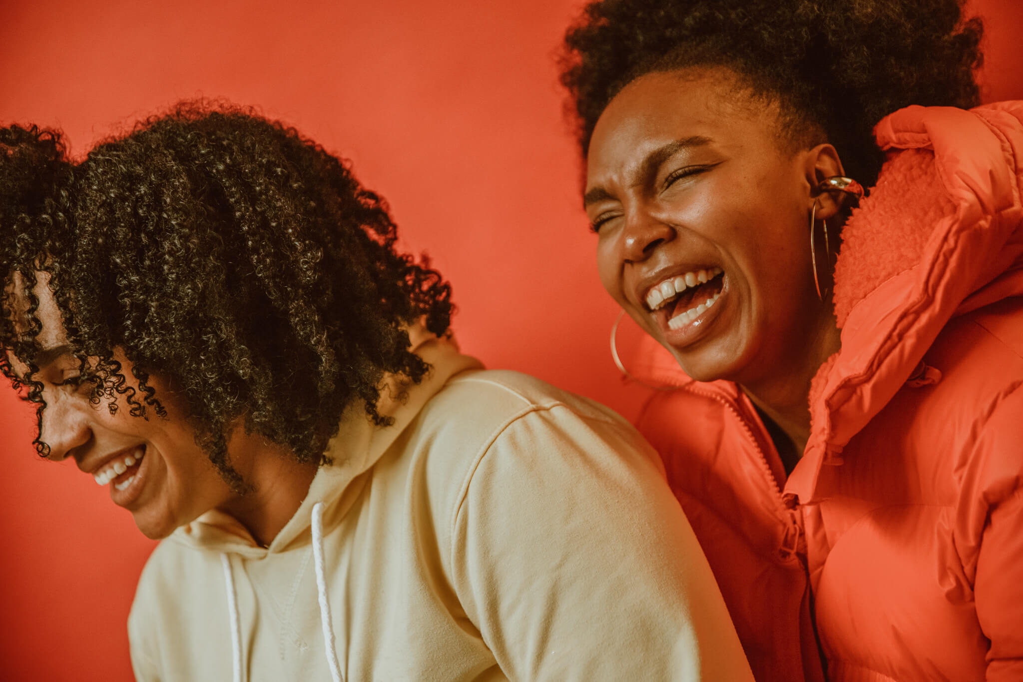 Two women laugh heartedly and without restraint.