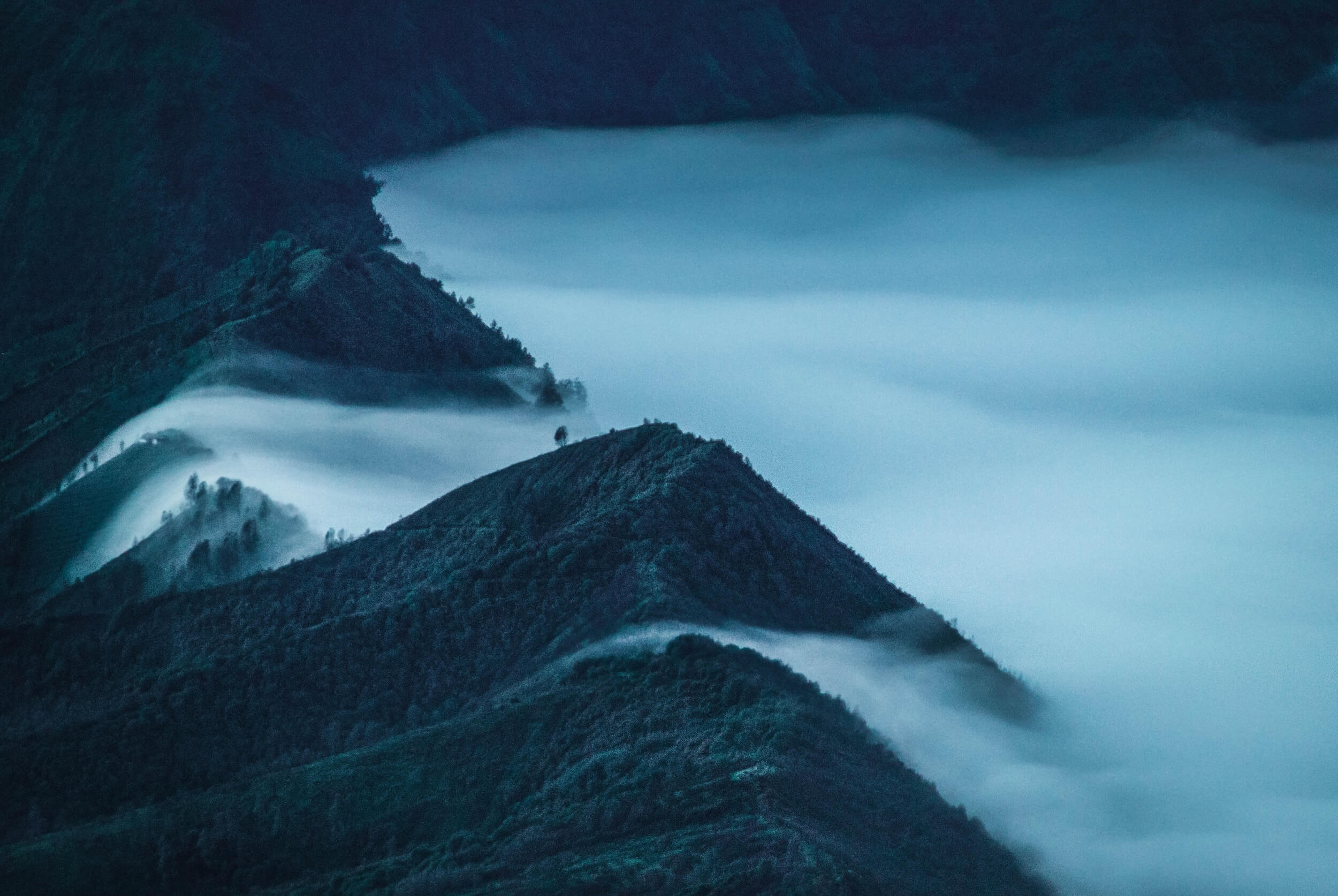 Fog moves in over mountains.