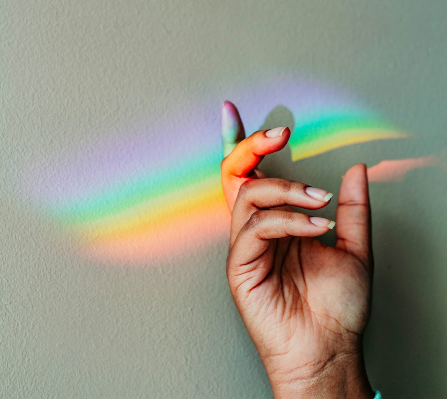 A woman holds a rainbow.